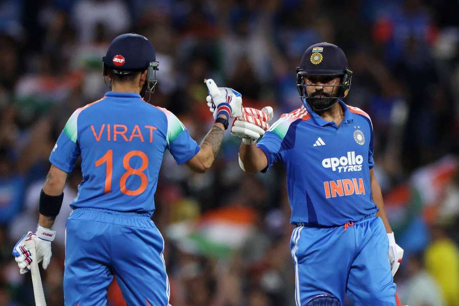 India's Rohit Sharma celebrates with Virat Kohli after hitting six runs off the bowling of Australia's Adam Zampa India's Rohit Sharma celebrates with Virat Kohli after hitting six runs off the bowling of Australia's Adam Zampa