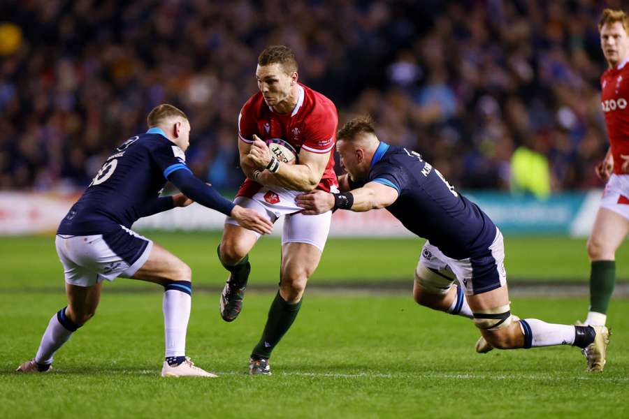 George North in action with Scotland's Finn Russell and Matt Fagerson