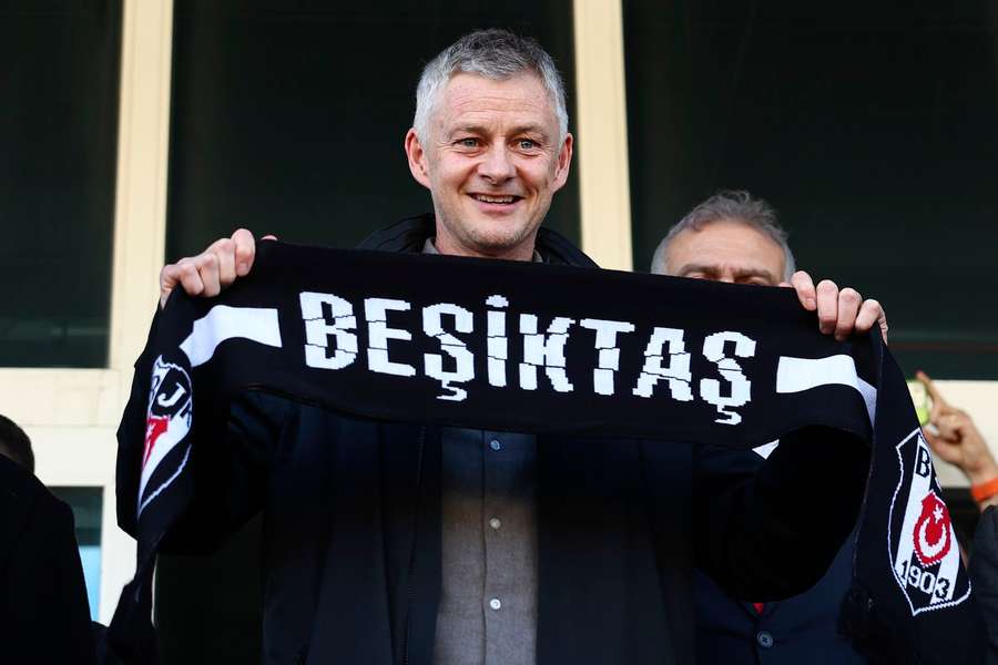 Ole Gunnar Solskjaer holds a Besiktas scarf after being appointed head coach 