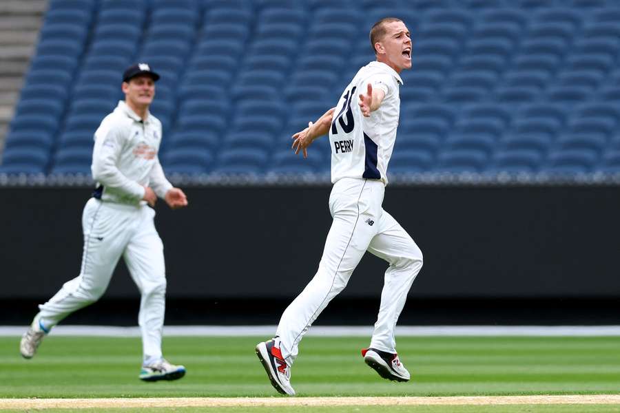 Mitch Perry celebrates the wicket of Mitch Marsh at the MCG on Thursday morning.