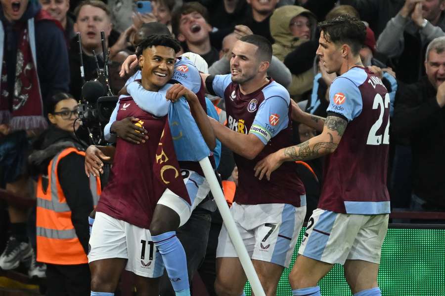 Aston Villa's English striker Ollie Watkins (L) celebrates with teammates after scoring their third goal 