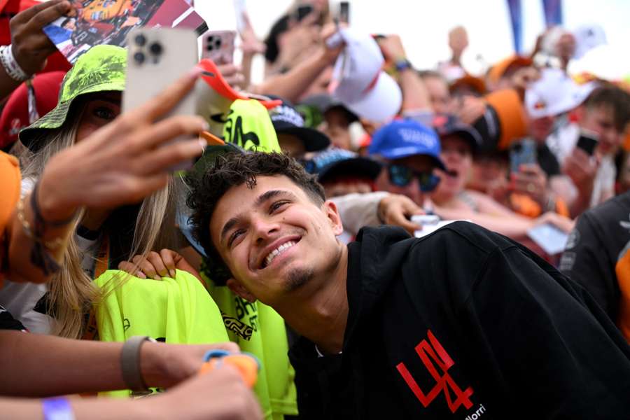 Norris takes pictures with the fans