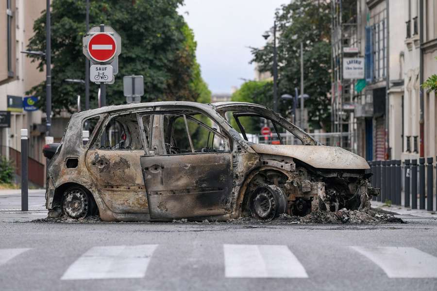 The remains of a burnt out car following a night of looting and rioting in Montreuil, near Paris