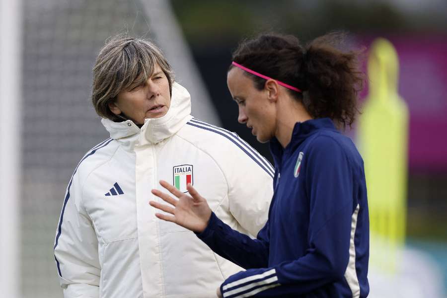 Milena Bertolini talks to Barbara Bonansea in training ahead of their winner-takes-all clash against South Africa