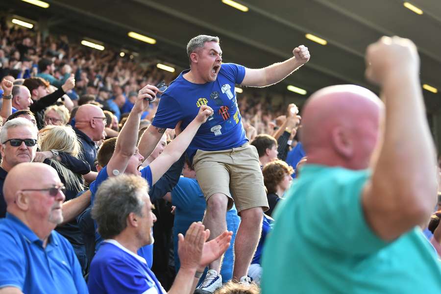 Everton's fans celebrate their team's opening goal