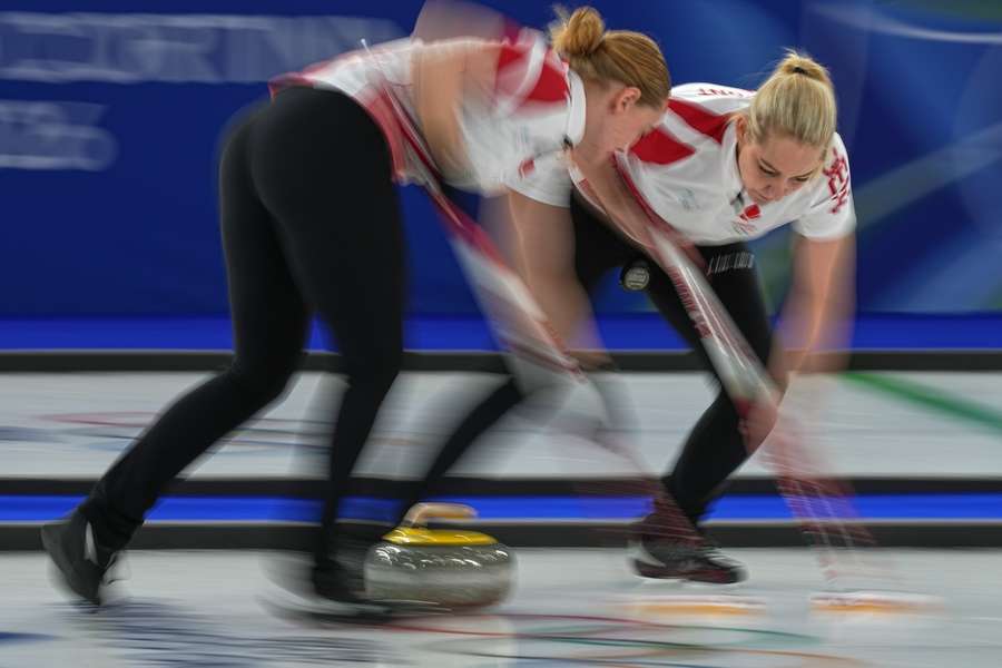 Denmark's Denise Dupont and Mathilde Halse in action during the women's curling round robin session against Switzerland