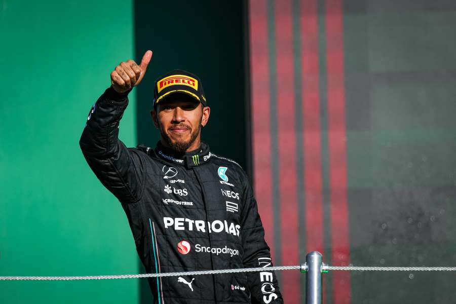 Mercedes' British driver Lewis Hamilton celebrates on the podium after placing second in the Formula 1 Mexico Grand Prix