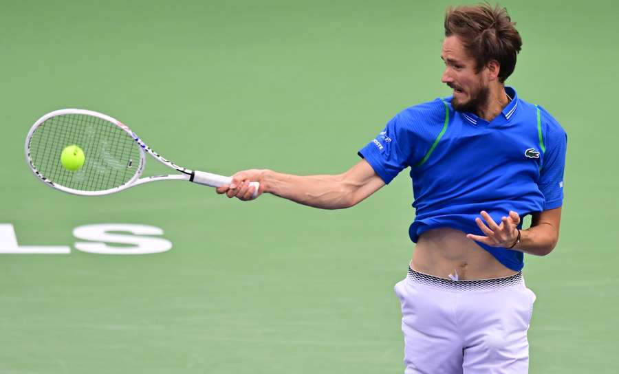 Daniil Medvedev of Russia hits a forehand return to Carlos Alcaraz of Spain