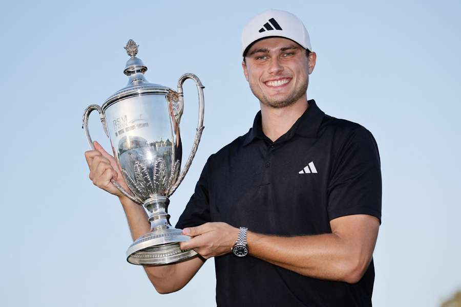 Ludvig Aberg poses with the trophy after winning the RSM Classic in Georgia