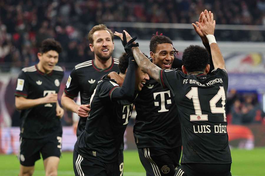 Michael Olise of Bayern Munich celebrates scoring his team's fifth goal with teammates