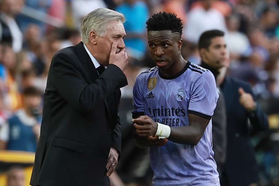 Ancelotti (L) alongside Vinicius Junior