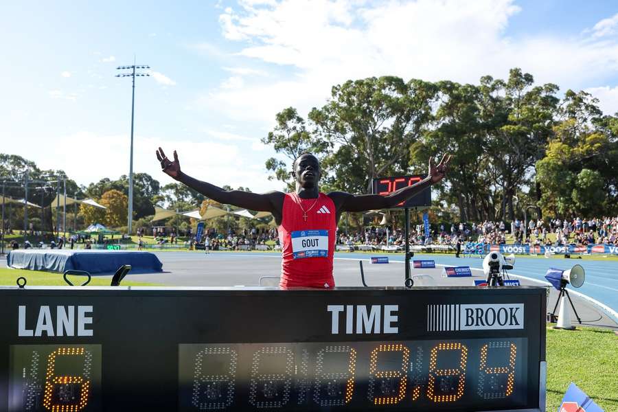 Gout Gout poses next to his time of 19.84 after winning the men's 200m final during the Australian Athletics Championships in Perth