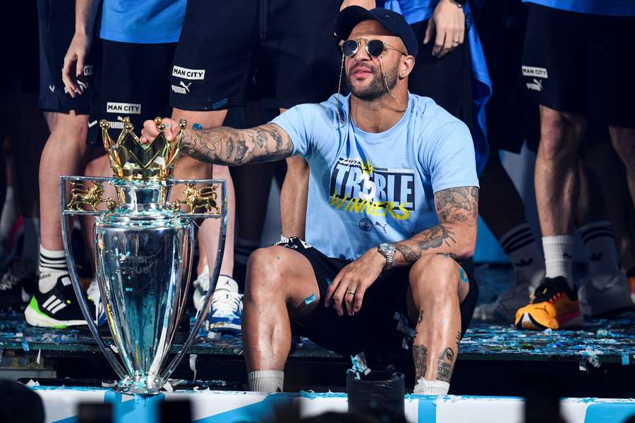 Kyle Walker sits with the Premier League trophy