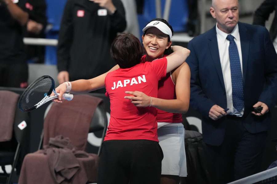 Uchijima (R) celebrates with Japan team captain Ai Sugiyama