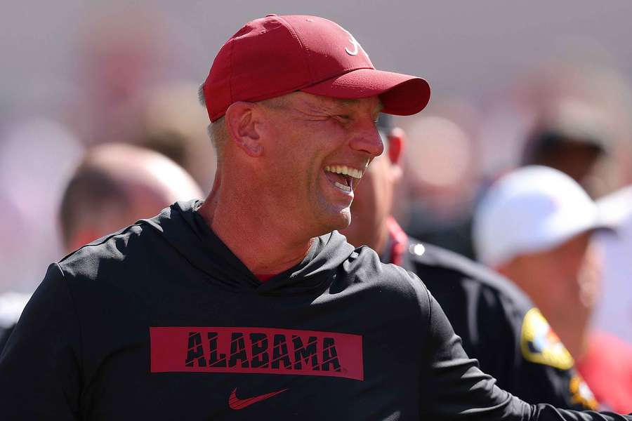 Alabama head coach Kalen DeBoer smiling on the sideline during a game (2024)