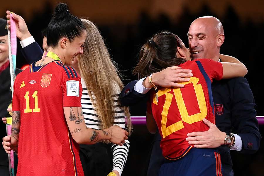 Luis Rubiales hugs defender Rocio Galvez while the next player in line, Jenni Hermoso, collects her winner's medal