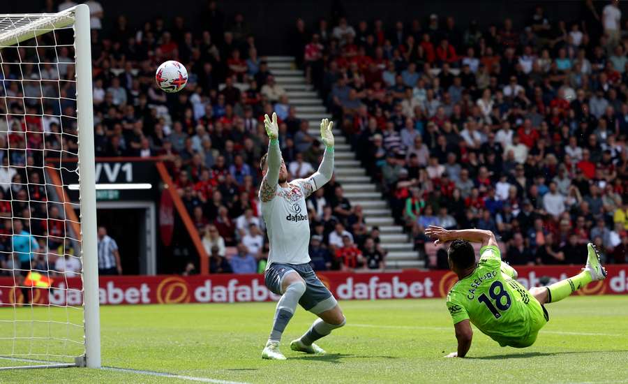 Manchester United midfielder Casemiro (R) scores the opening goal