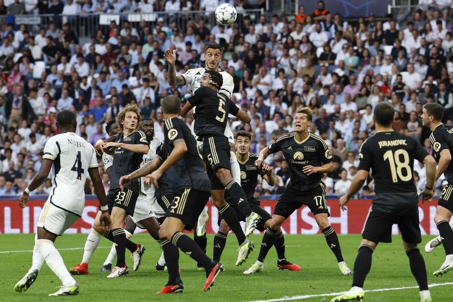 Real Madrid's Joselu and Union Berlin's Danilho Doekhi vie for a header