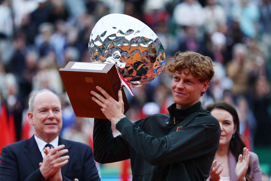Jannik Sinner celebrates with the trophy after winning his final against Spain's Carlos Alcaraz at Monte Carlo