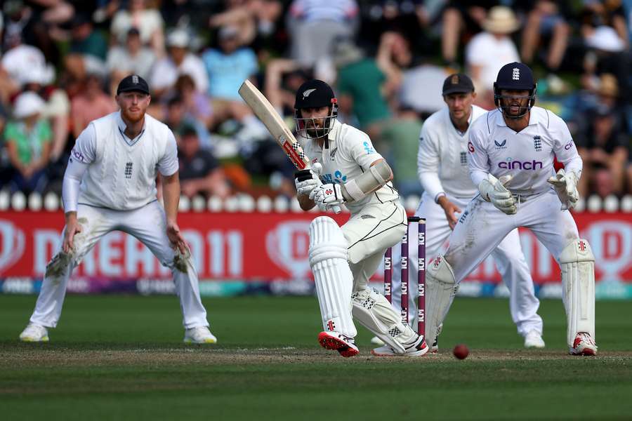 New Zealand's Kane Williamson (C) plays a shot