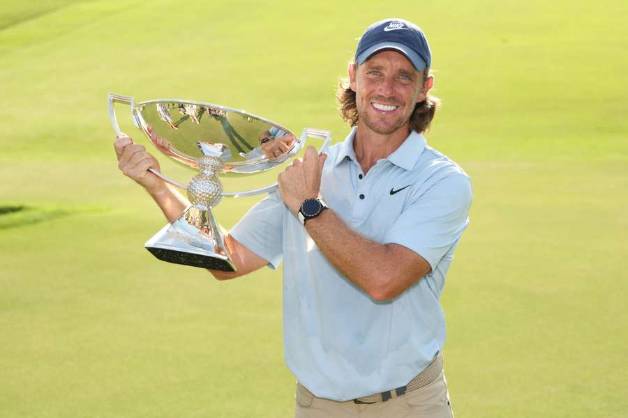 Tommy Fleetwood poses with the Tour Championship trophy.