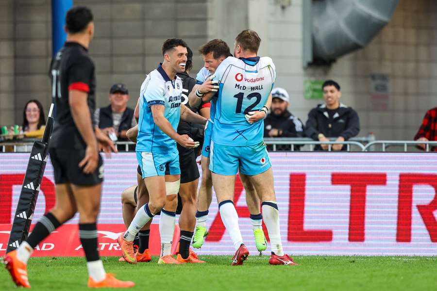 Scotland's players celebrate a try during their rugby match between New Zealand Maori and Scotland at Semenoff Stadium in Whangarei