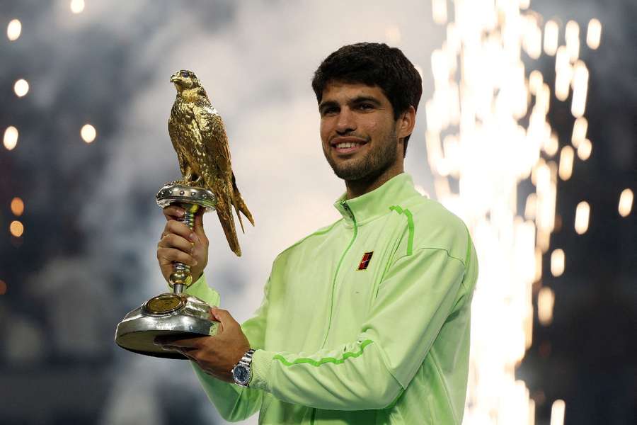 Carlos Alcaraz lifts the trophy in Doha