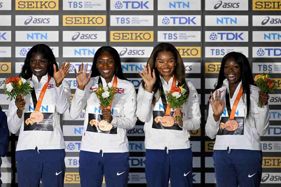 Asha Philip, Imani Lansiquot, Bianca Williams and Daryll Neita celebrate during the podium ceremony for the women's 4x100m relay