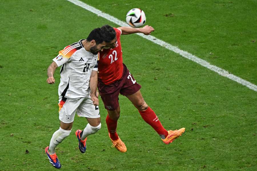 Germany's midfielder Ilkay Gundogan and Switzerland's defender Fabian Schaer vie for the ball