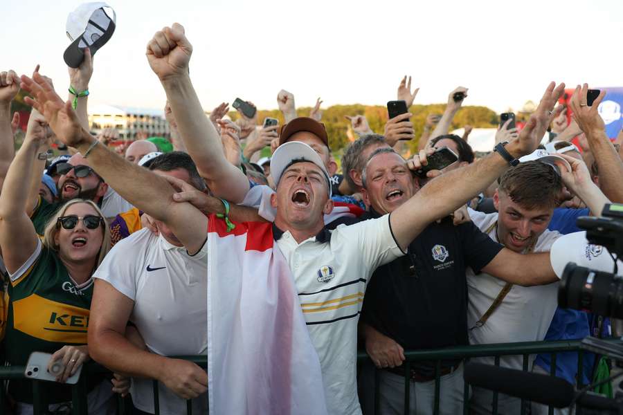 Rory McIlroy celebrates with supporters after being heckled by US fans