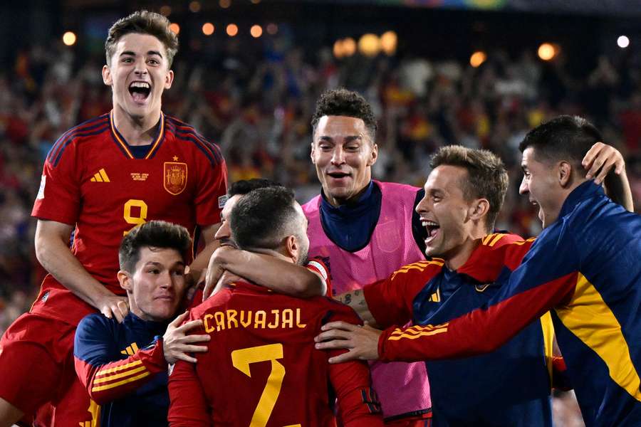 Spain's players celebrate after winning the penalty shootout