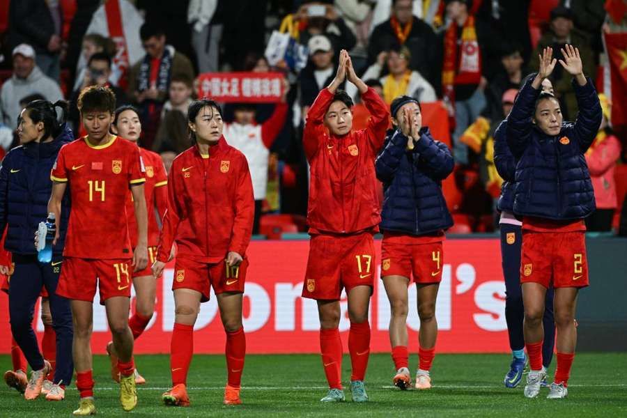 China's players applaud their supporters following their 6-1 defeat against England