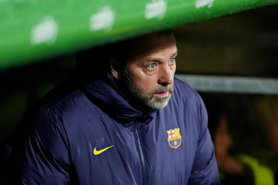 Barcelona boss Flick looks on from the dugout