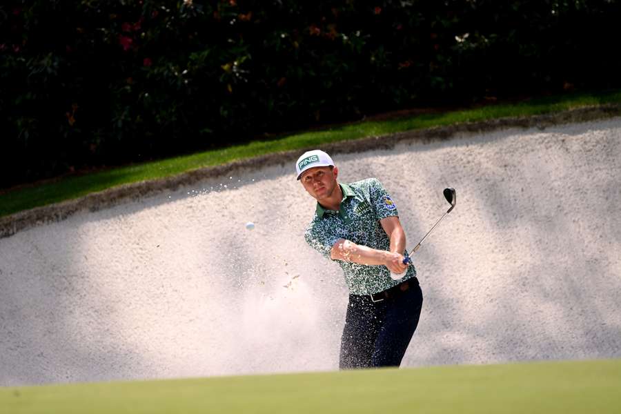 Mackenzie Hughes plays a shot from a bunker on the 13th hole