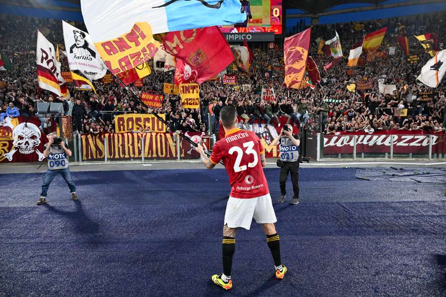 Mancini celebrates with the Roma fans after their derby win