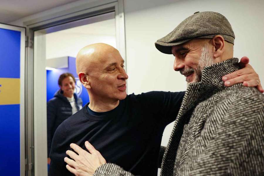 Corini (L) greets Guardiola