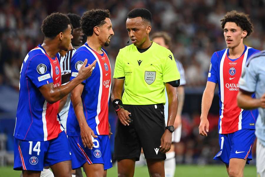 Referee Omar Artan speaks with PSG captain Marquinhos during the 2026 UEFA Super Cup final