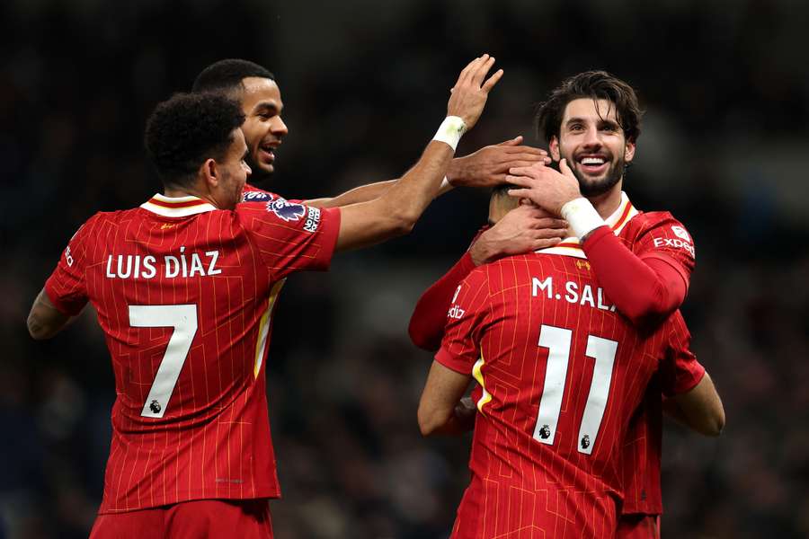 Liverpool players celebrate together after Salah scores
