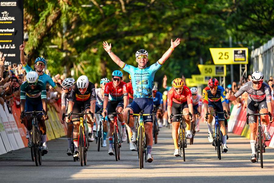 Mark Cavendish celebrates as he crosses the line to win his farewell race at the Singapore Criterium