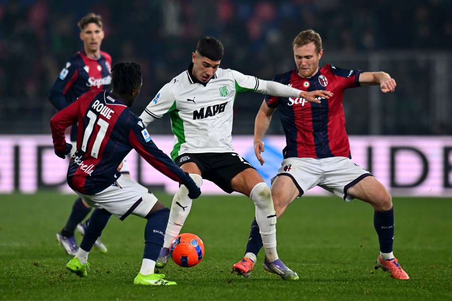 Cristian Volpato of Sassuolo, centre, competes for the ball with Tommaso Pobega