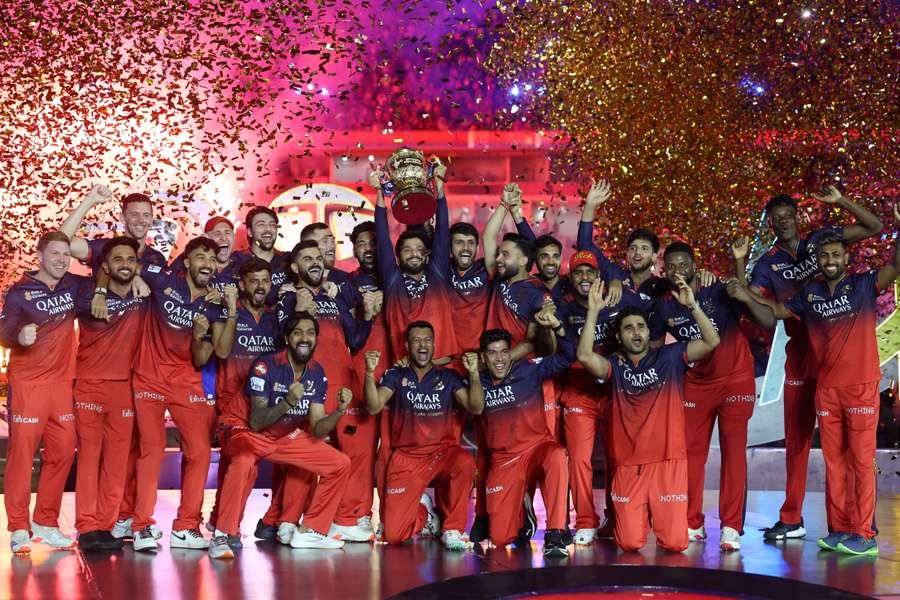 Royal Challengers Bengaluru players celebrate with the trophy after winning the Indian Premier League