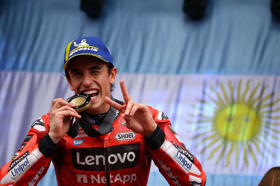 Marc Marquez poses for a photo with his medal on the podium in Argentina