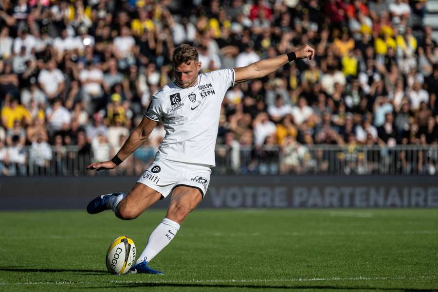 Toulon's Welsh fly-half Dan Biggar kicks the ball