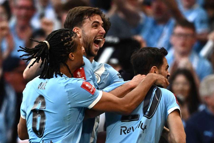 Nico Gonzalez celebrates scoring their winning goal with Bernardo Silva and Nathan Ake