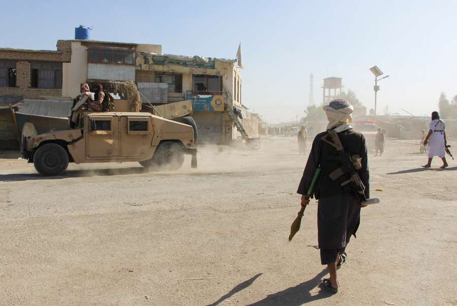 Afghan Taliban fighters patrol near the Afghanistan-Pakistan border