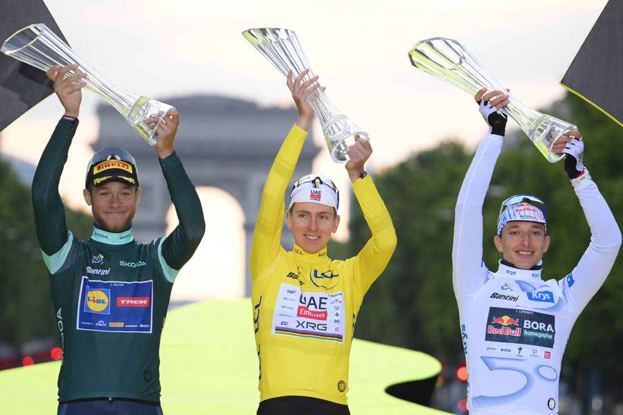 Tadej Pogacar, wearing the overall leader's yellow jersey, Jonathan Milan (left) and Florian Lipowitz celebrate on the podium Tadej Pogacar, wearing the overall leader's yellow jersey, Jonathan Milan (left) and Florian Lipowitz celebrate on the podium