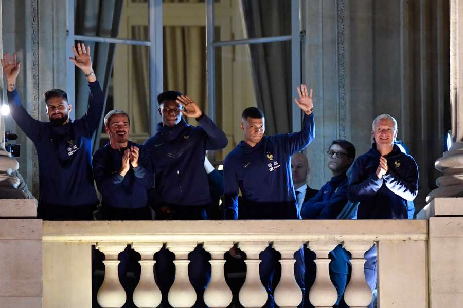 The squad took turns to stand on the Crillon Hotel balcony overlooking the Place de la Concorde