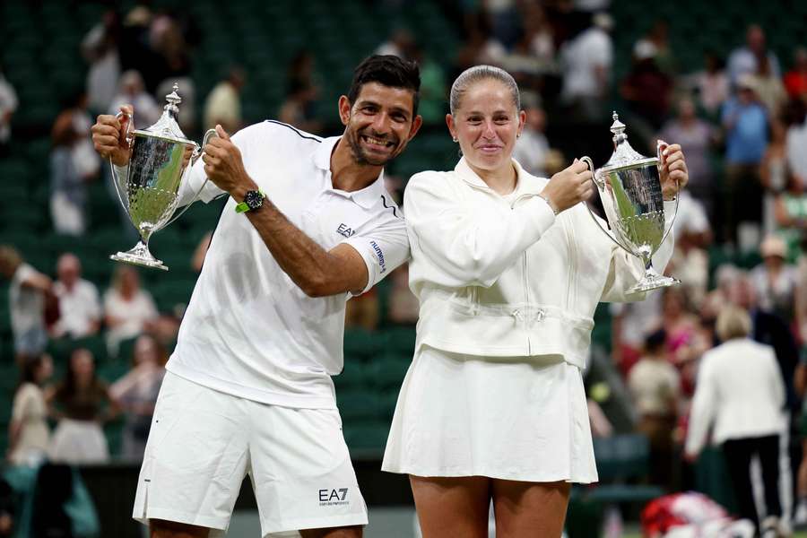 El Salvador's Marcelo Arevalo and Latvia's Jelena Ostapenko pose with the trophies after winning their mixed doubles final at Wimbledon El Salvador's Marcelo Arevalo and Latvia's Jelena Ostapenko pose with the trophies after winning their mixed doubles final at Wimbledon
