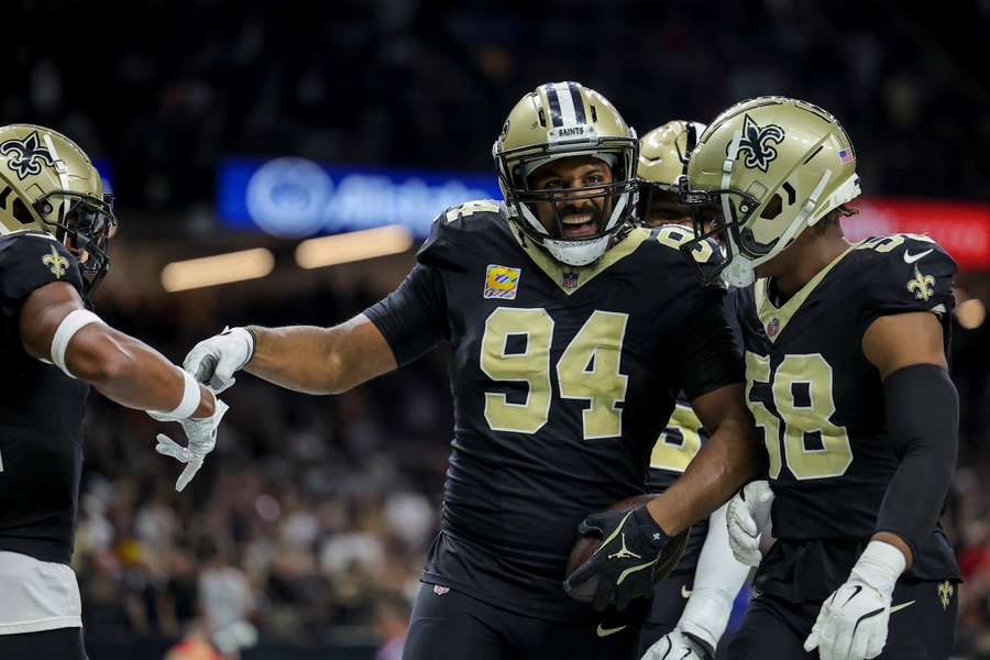 Cameron Jordan celebrates an interception with teammates (2024)