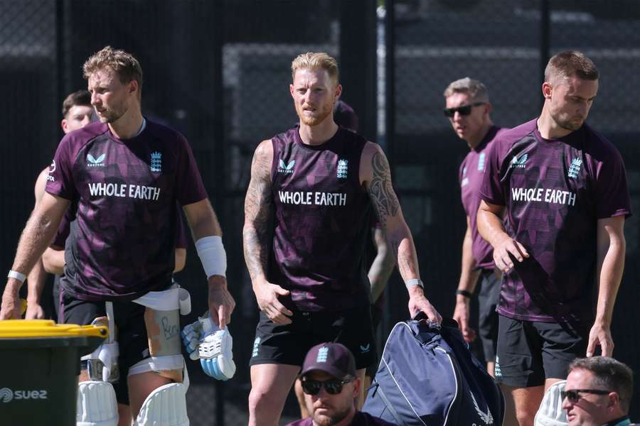 England's Joe Root (L) and Ben Stokes prepare to bat during a training session at The Gabba